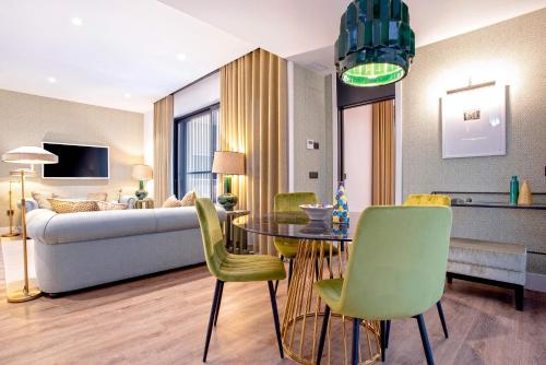 a living room with a couch and a table and chairs at Genteel Home Betis 67 in Seville
