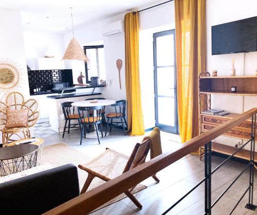 a living room with a couch and a table at Résidence du Platane in Saint-Laurent-des-Arbres
