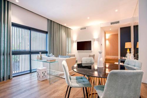 a living room with a table and chairs at Genteel Home Betis 67 in Seville