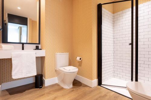 a bathroom with a toilet and a sink and a shower at Genteel Home Betis 67 in Seville