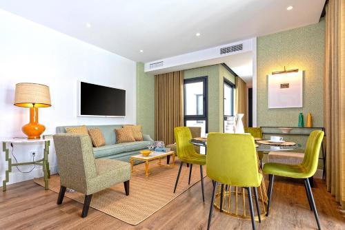 a living room with a couch and a table and chairs at Genteel Home Betis 67 in Seville