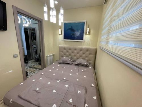 uma pequena cama num quarto com uma janela em 1 Bedroom stylish apartment in TSUM em Tashkent