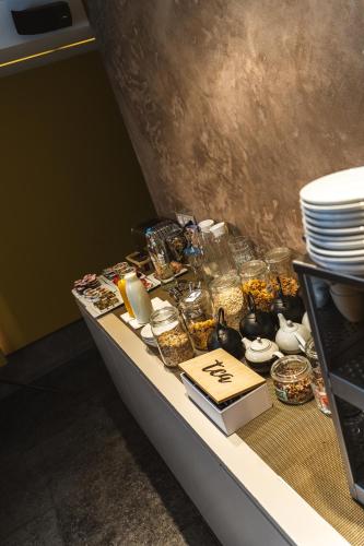 a table with plates and other items on it at Hotel de la Paix in Poperinge