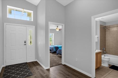 a room with a bathroom with a toilet and a tub at Amazing 4 Bedrooms 3 Bath with private pool, near Disney and Universal! in Davenport