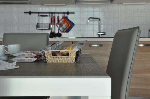 a table with a basket of food on it in a kitchen at Ai Santi B&B in Dossobuono