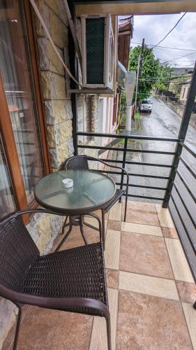 a balcony with a table and chairs on a balcony at Shera in Borjomi