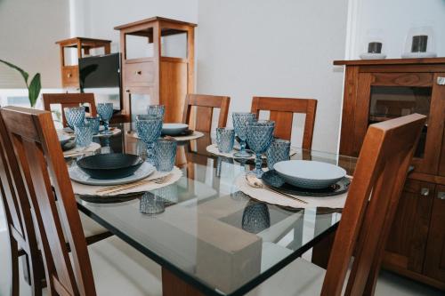 a dining room with a glass table and chairs at Meu Lar in Rianjo
