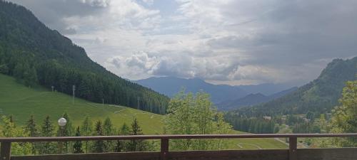 a view from a balcony of a valley with mountains at Casa Natura in Castione della Presolana