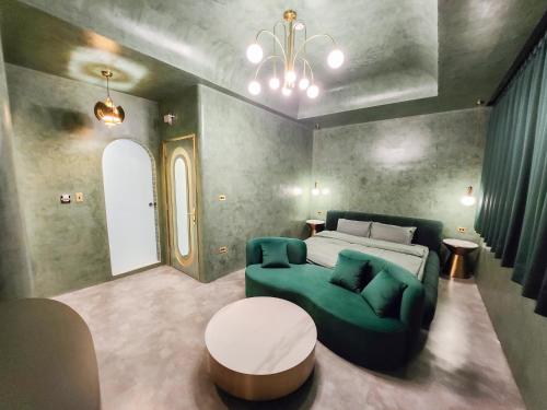 a bedroom with a bed and a green couch at ART BnB in Tainan