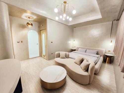 a bedroom with a bed and a couch and a table at ART BnB in Tainan