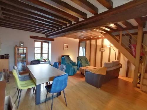 a living room with a table and chairs at Sunset Family Guesthouse Mont Saint Michel in Céaux
