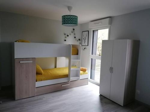 a bedroom with a bunk bed and a sliding door at Sunset Family Guesthouse Mont Saint Michel in Céaux