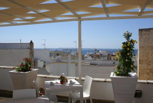 ガリポリにあるB&B Dimora Muzio and Restaurantの屋上にテーブルと椅子が2脚あるパティオ
