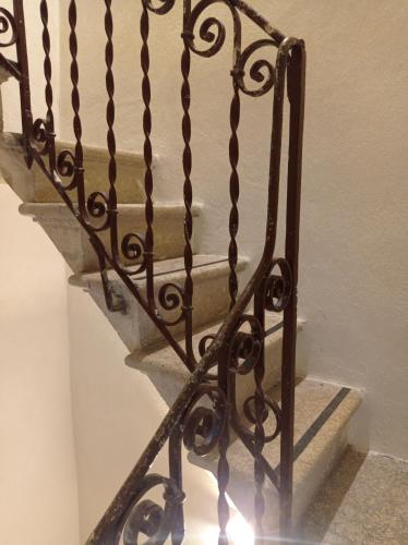 a wrought iron stair railing in a room at casa ANNA in Trapani