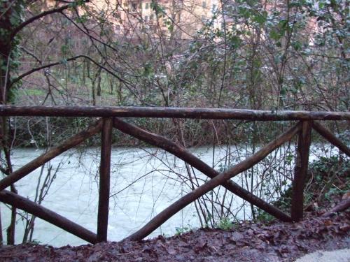 a wooden bridge in front of a river at Il casale di Pino e Rita in Subiaco