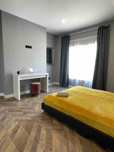 a bedroom with a bed and a desk and a window at Modern and spacious house with Hot Tub in Lincolnshire