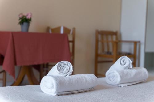 two rolls of towels sitting on a table at Ammousa Hotel Apartments in Lixouri