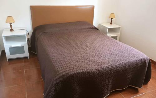 a bedroom with a bed and two night stands at Casa da Costureira in Olival