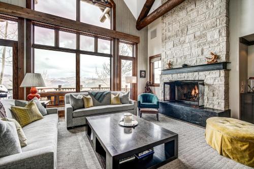 a living room with a couch and a fireplace at Bachelor Gulch Horizon Pass Private Townhome in Beaver Creek