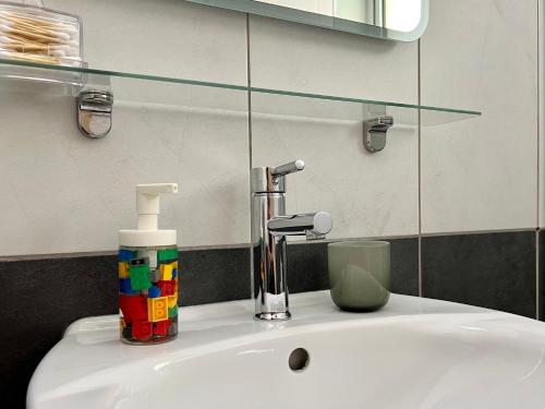 a bathroom sink with a glass shelf above it at Fat Cow Apartment 103 in Larnaka