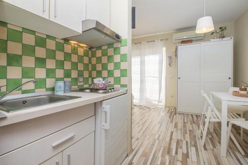 a kitchen with a sink and a counter top at LunArta Apartments in Makarska