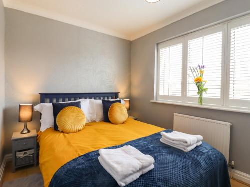 a bedroom with a bed with towels on it at 23 Brandeston Close in Sudbury