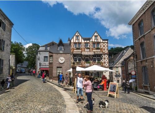 a group of people walking a dog on a street at Au chant des oiseaux in Rochefort