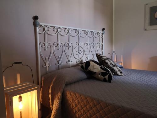 a bedroom with a bed with a metal headboard at Casa degli Ulivi Etna in Ragalna