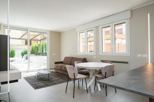 a living room with a table and chairs and a couch at Viam Imbriani Suites in Rome
