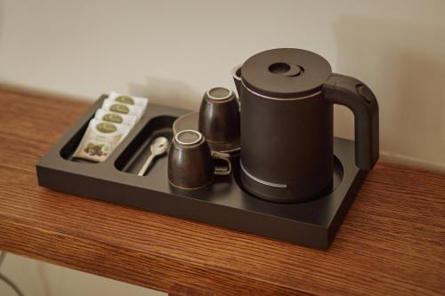 a coffee maker on a table with a remote control at Casa Manor Boutique Hotel in Tivat