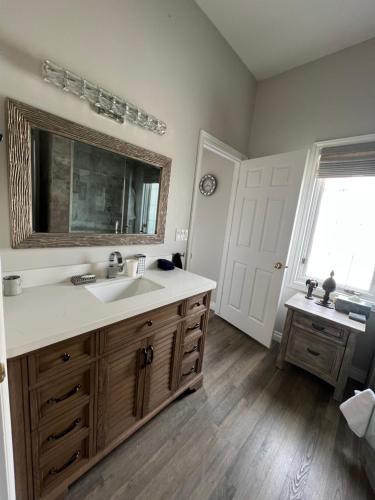 a bathroom with a sink and a mirror at Lady MacDonald Country Inn in Canmore