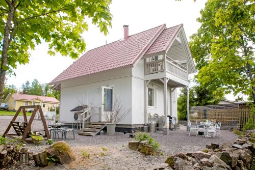 a white house with a sign on it at Villa Vivante in Porvoo