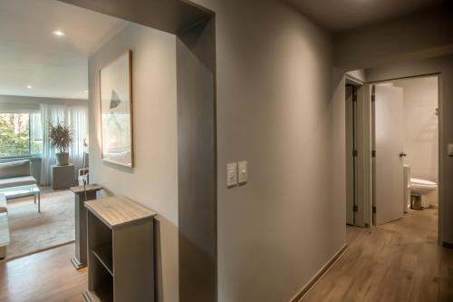 a hallway of a home with a living room at Luxurious 1BR Overlooking Lima Golf Club in Lima