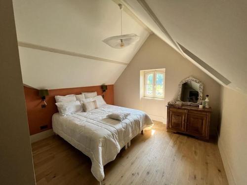 a bedroom with a large bed and a mirror at Les Palissières in Mortagne-sur-Gironde