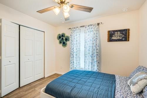 a bedroom with a blue bed and a ceiling fan at Newly-Built Home with Yard and Patio in Inverness! in Inverness