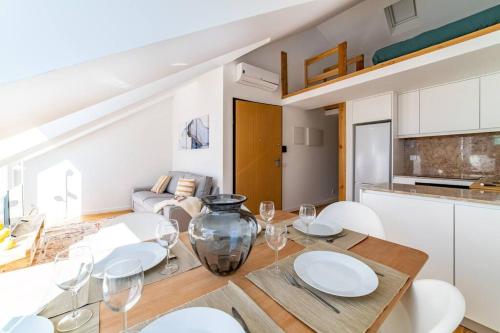 a kitchen and dining room with a table and chairs at Amaro III - Stunning penthouse apartment in Alcantara in Lisbon