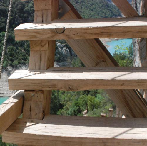a wooden bench on a deck with a view at Casa Cosialls in Benabarre