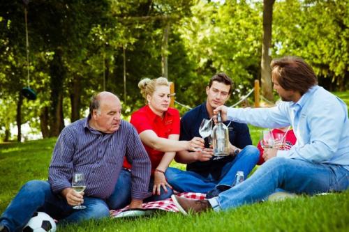 a group of people sitting on the grass at Istvándy Birtok in Káptalantóti