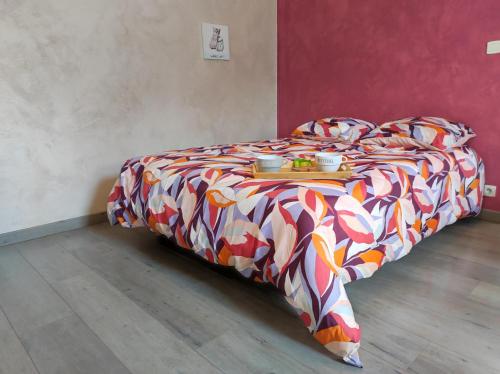 a bed with a tray of food on top of it at Studio La Tan'Eure in Chartres