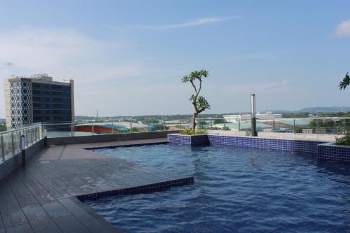 a swimming pool on the roof of a building at Galeno Pollux Habibie in Batam Center