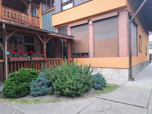 a building with flower boxes on the side of it at Kismarosi Center Apartman in Kismaros