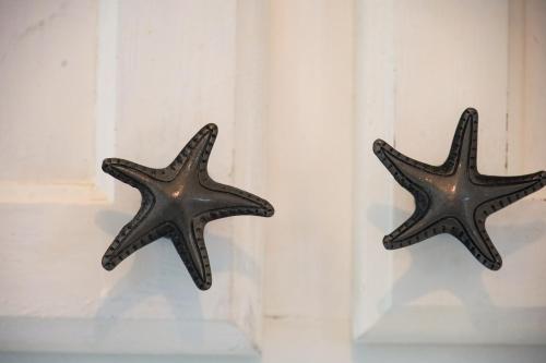 two starfish are hanging on a wall at SeaRenity by the Sea - Luxury & Romance Await in Myrtle Beach