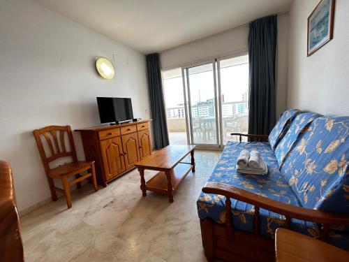 a living room with a couch and a tv at Gemelos 22-Fincas Benidorm in Benidorm