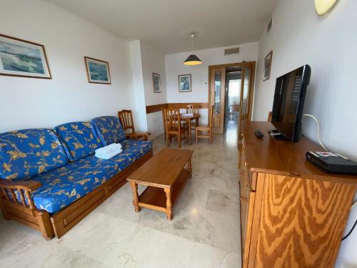 a living room with a couch and a tv at Gemelos 22-Fincas Benidorm in Benidorm