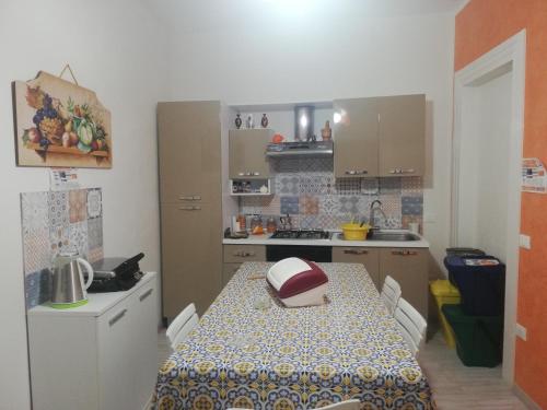 a kitchen with a table and a kitchen with a sink at Casa Anna Maria in Marsala