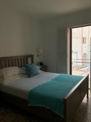 a bed in a bedroom with a large window at La Casa Al Mare in Polignano a Mare