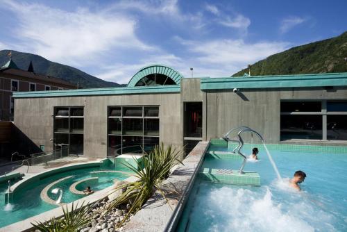 a man is in a swimming pool at cocoon 52 m2 new, beautiful view castle and mountain in Foix
