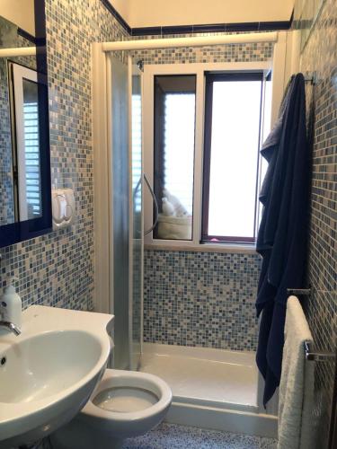 a bathroom with a shower and a sink and a toilet at La Casa Al Mare in Polignano a Mare