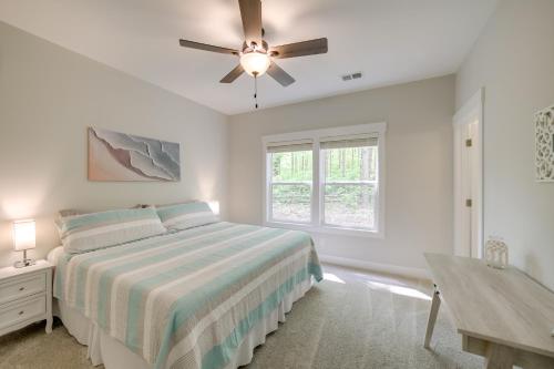 a white bedroom with a bed and a ceiling fan at Holland Home with Fire Pit Walk to Lake Michigan! in Holland
