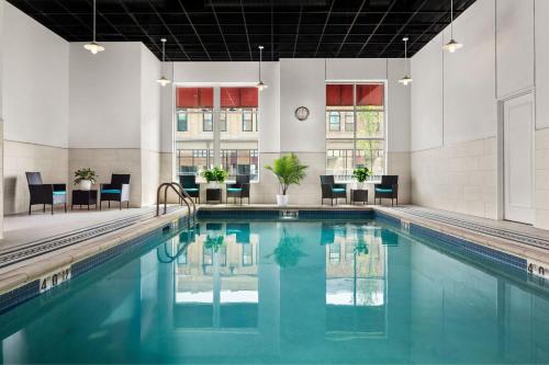 a swimming pool with blue water in a building at Sheraton Duluth Hotel in Duluth